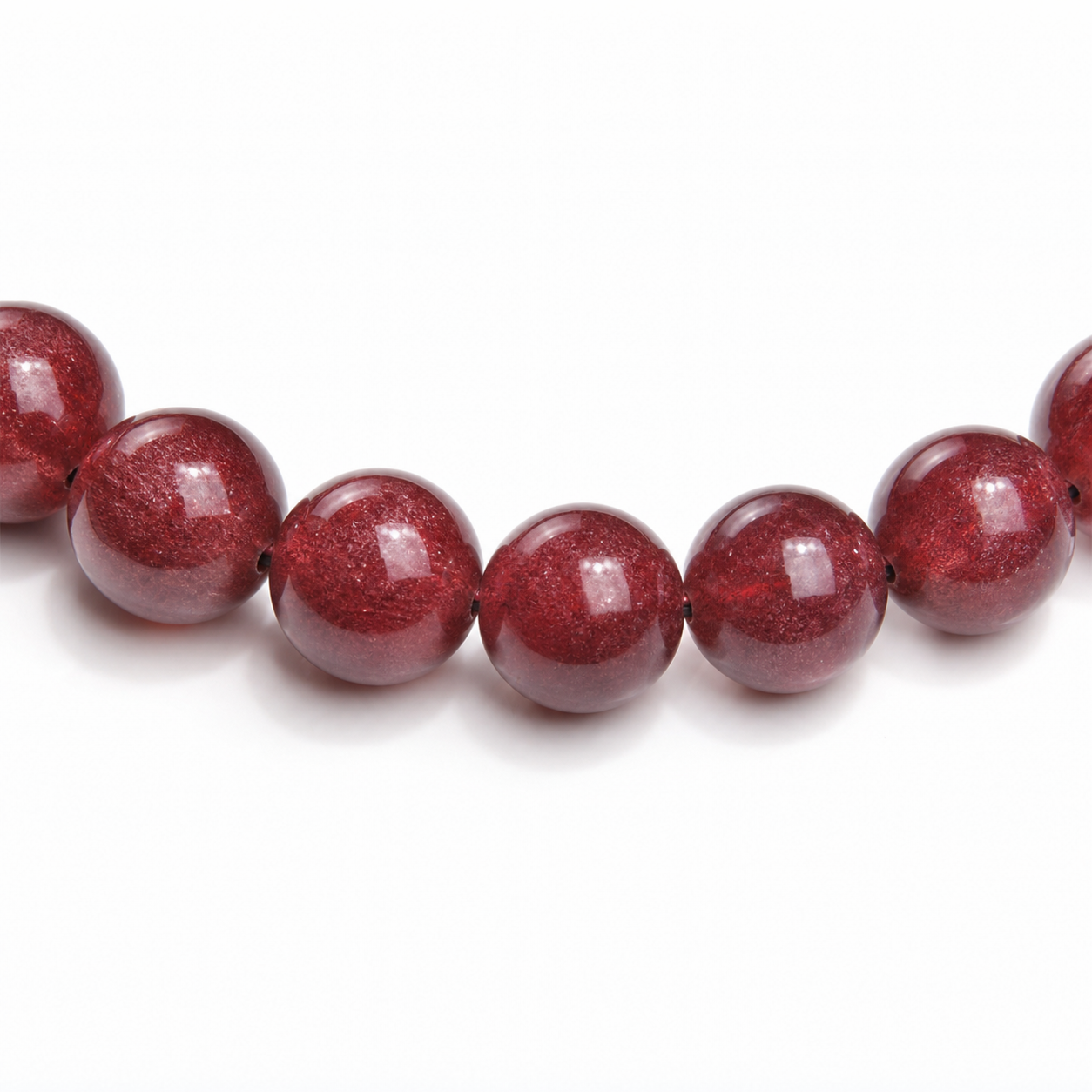 Close-up of Cherry Red Strawberry Quartz bead colour and surface detail