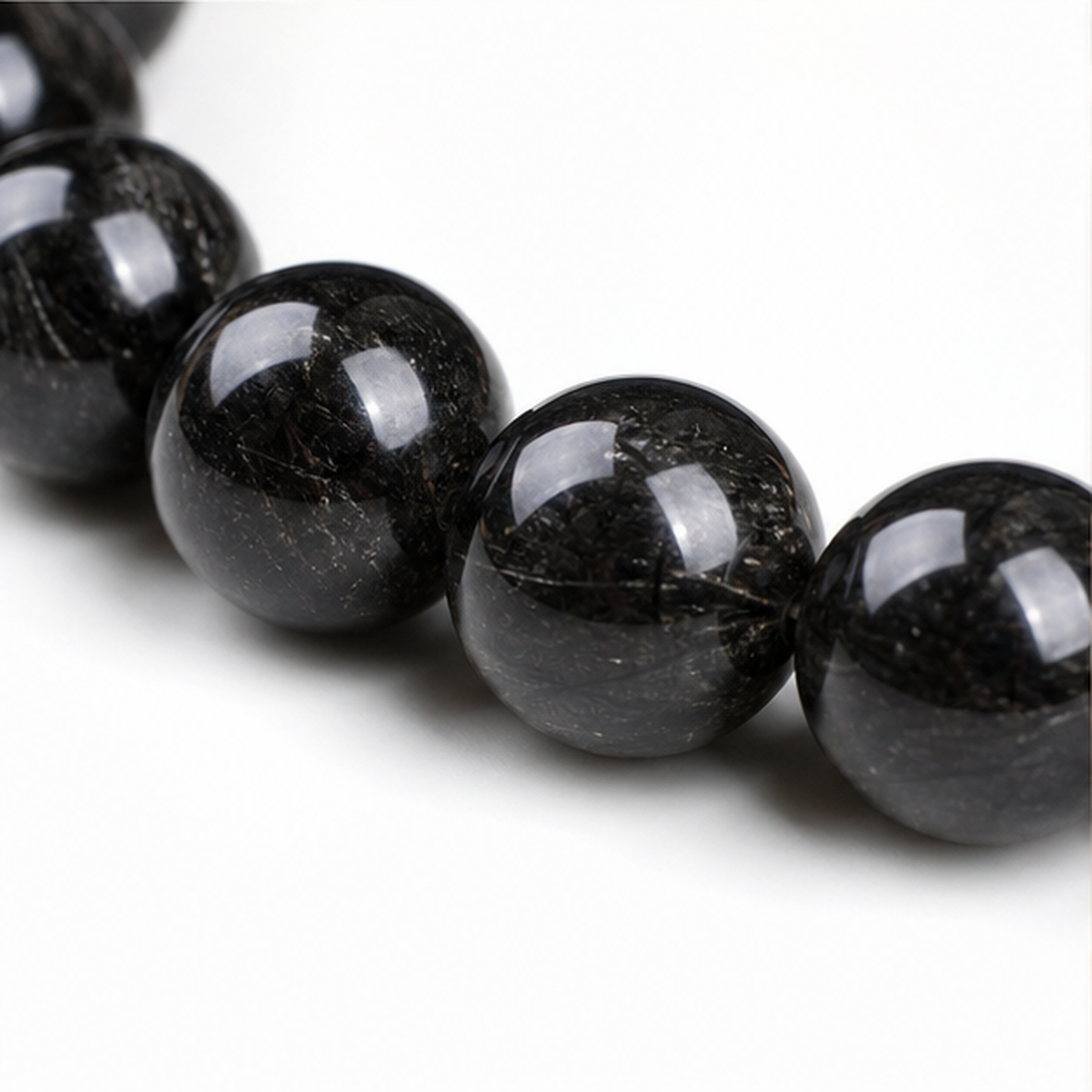 Close-up of Black Rutilated Quartz bead colour and surface detail