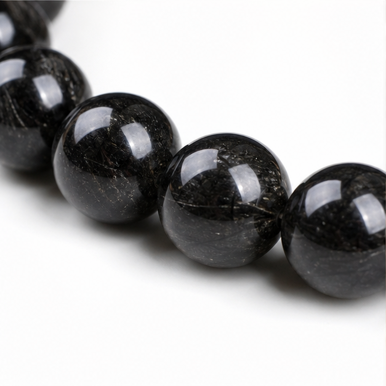 Close-up of Black Rutilated Quartz bead colour and surface detail