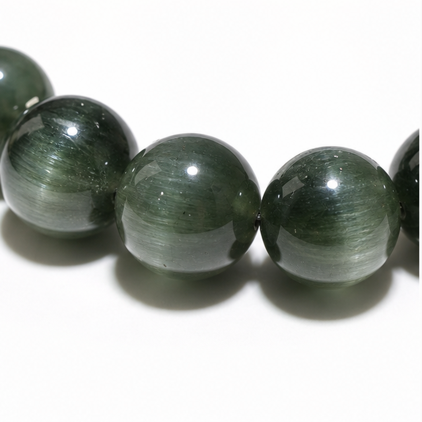 Close-up of Cat's-Eye Green Rutilated Quartz bead colour and surface detail