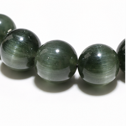 Close-up of Cat's-Eye Green Rutilated Quartz bead colour and surface detail