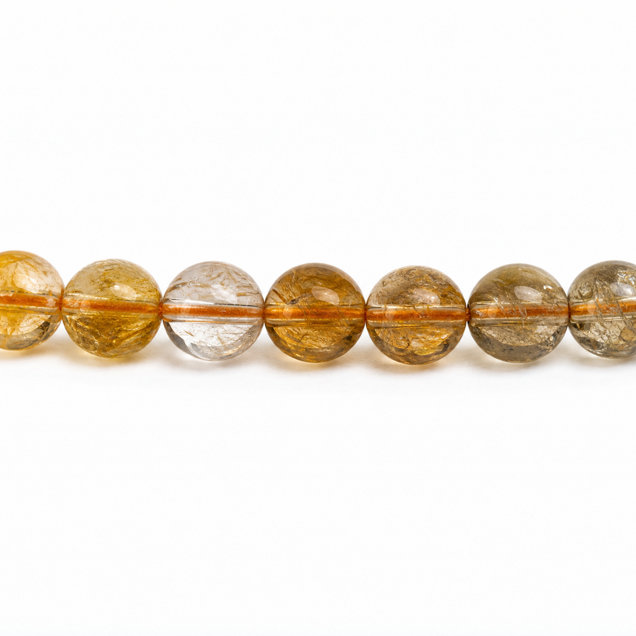Close-up of Titanium Rutilated Quartz bead colour and surface detail
