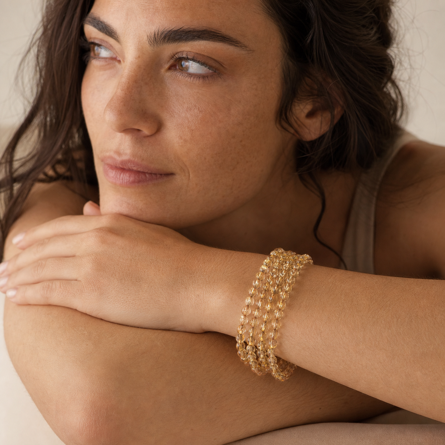 Titanium Rutilated Quartz worn by a woman with the bracelet in focus