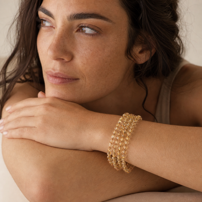 Titanium Rutilated Quartz worn by a woman with the bracelet in focus