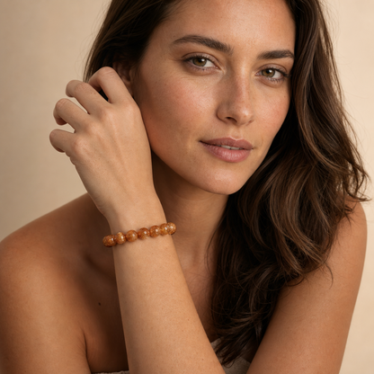 Copper Rutilated Quartz worn by a woman with the bracelet in focus