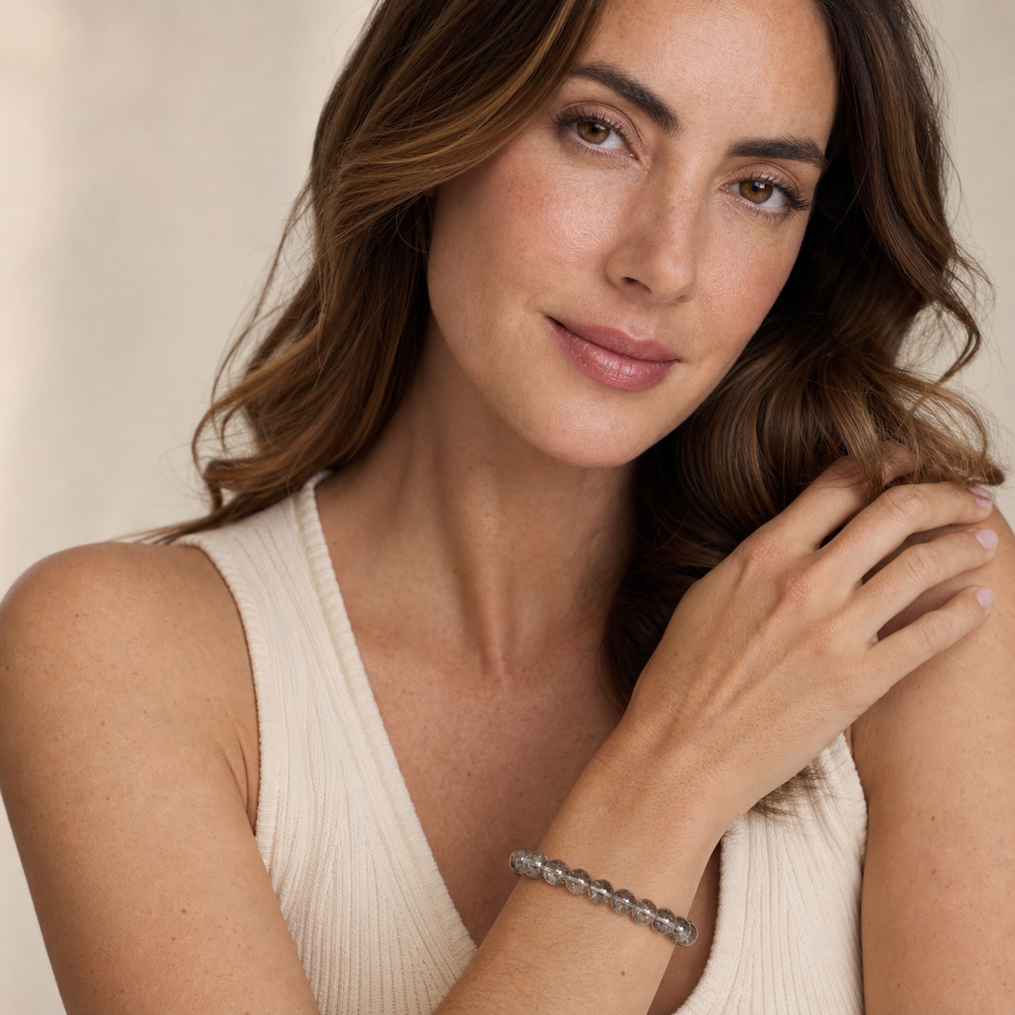 Silver Rutilated Quartz worn by a woman with the bracelet in focus