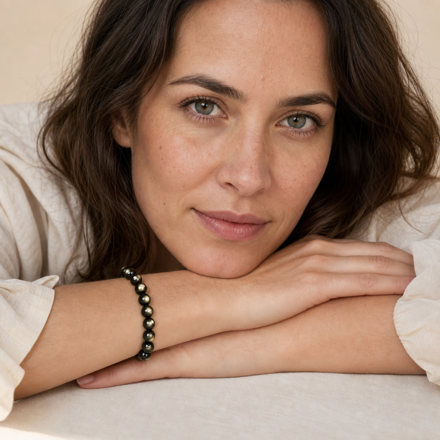 Gold Sheen Obsidian worn by a woman with the bracelet in focus