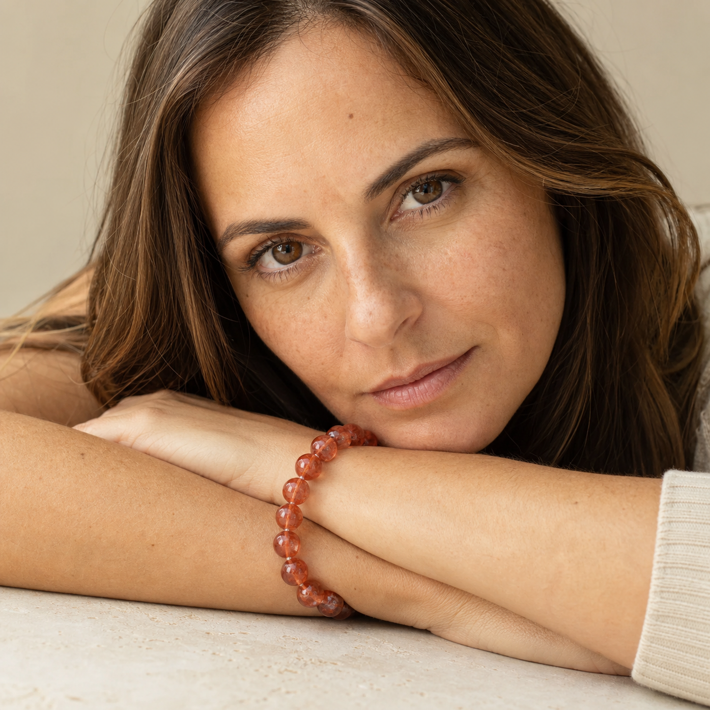 Red Hematoid Quartz worn by a woman with the bracelet in focus