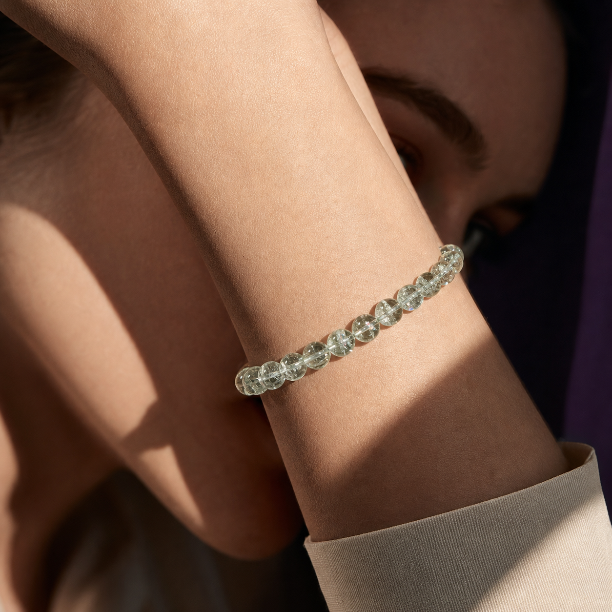 Green Azeztulite bracelet worn on a model's wrist